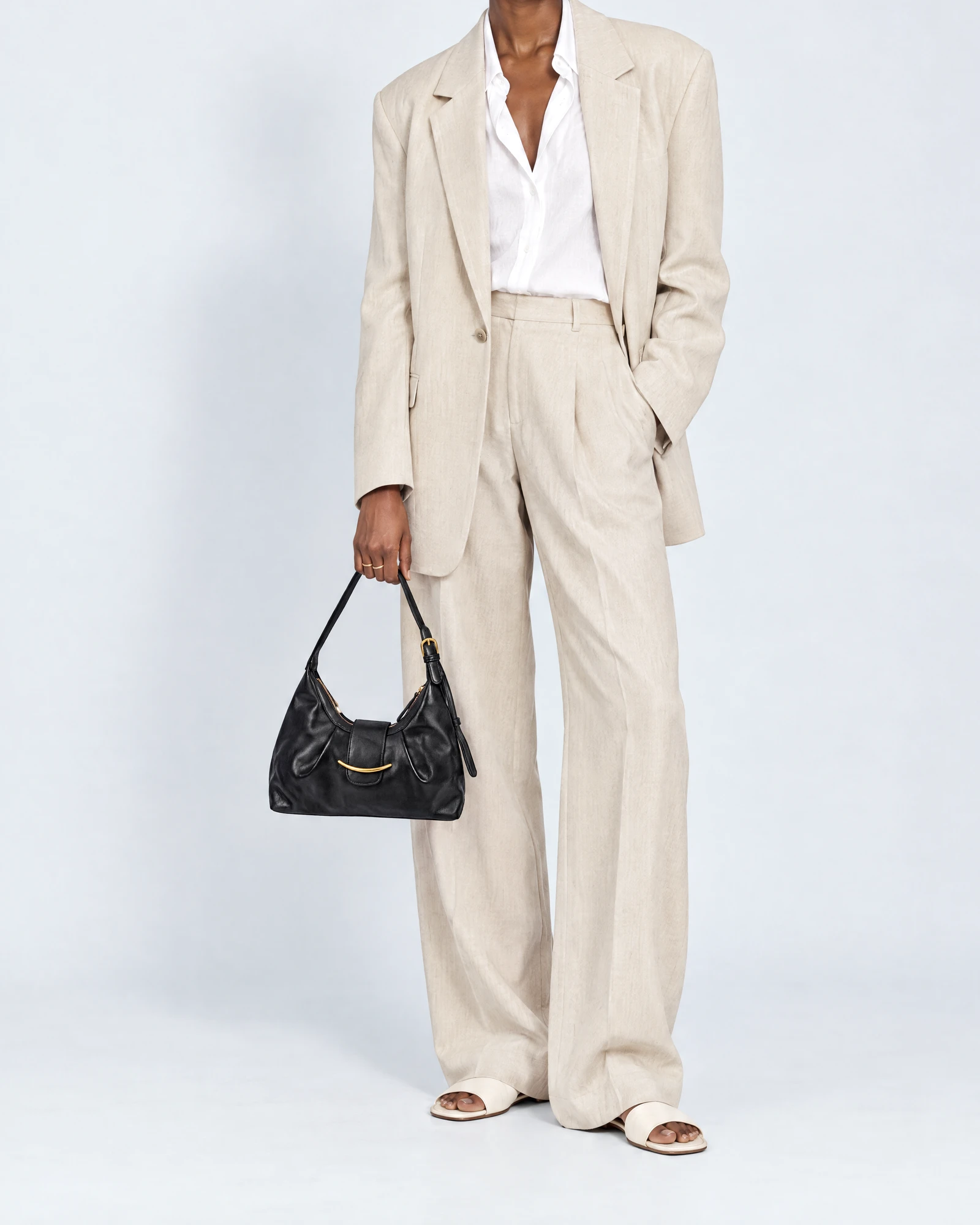 Black Leather Bag – Small, carried by a model