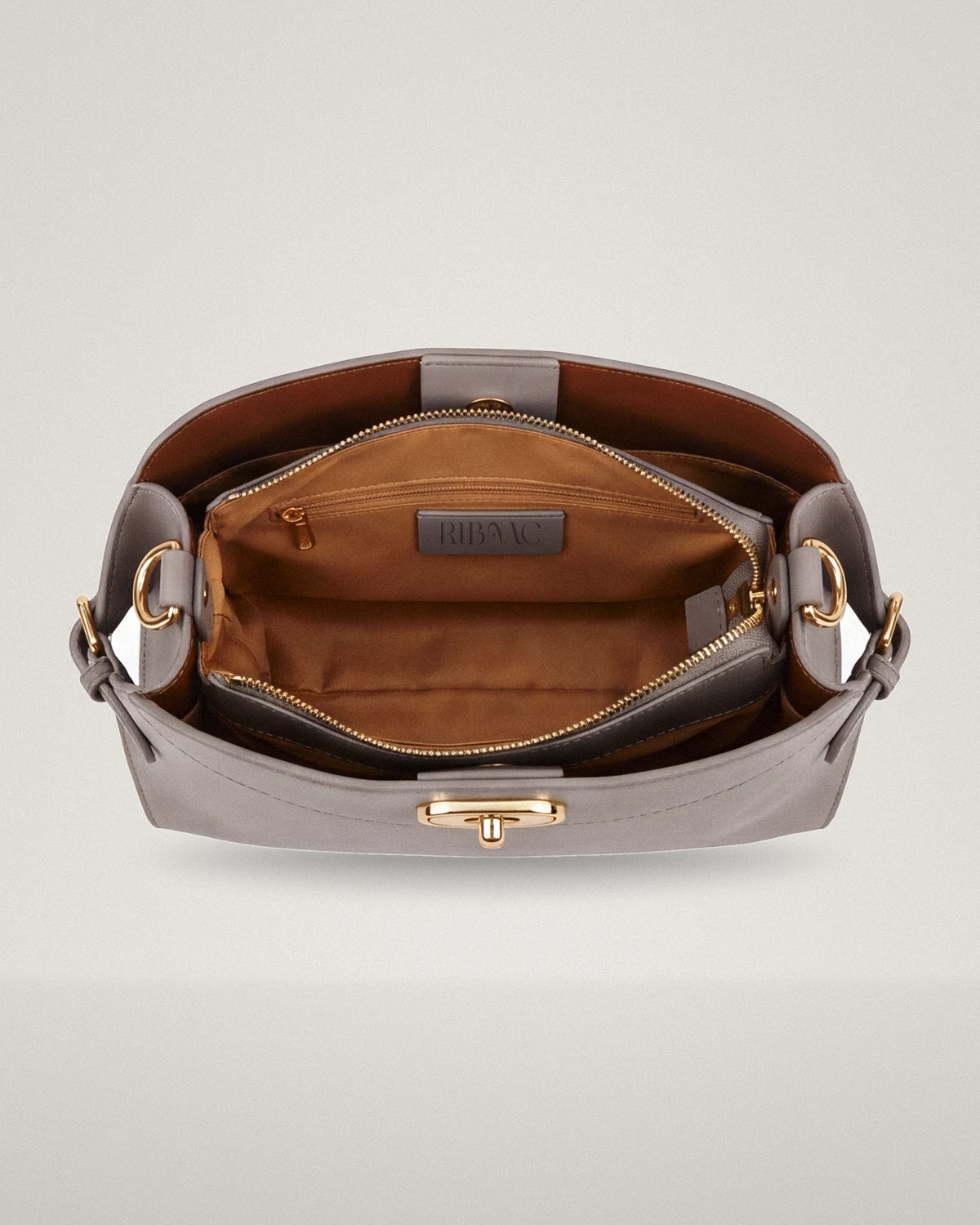 Caramel lining inside the gray leather top-handle bag